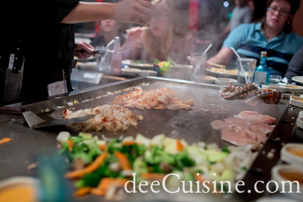 Chef cooks chicken, shrimp, lobster and steak